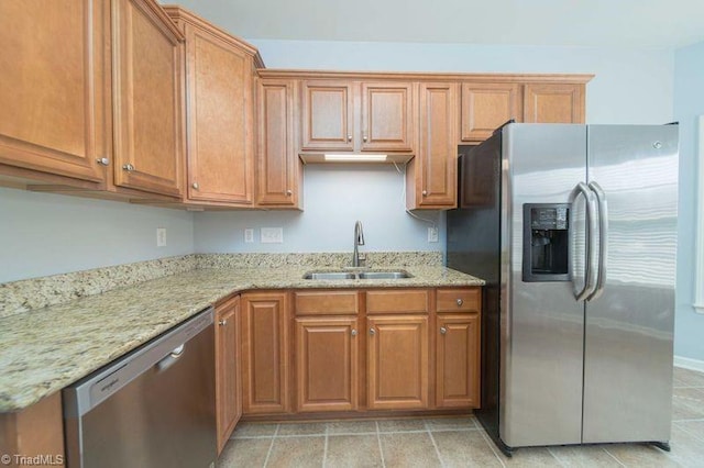 5306 Forester Dr, High Point, NC 27265 - kitchen with appliances with stainless steel finishes, a sink, light stone counters, and brown cabinetry