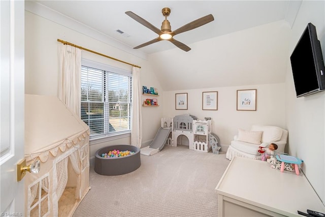 playroom featuring visible vents, baseboards, ceiling fan, light colored carpet, and vaulted ceiling