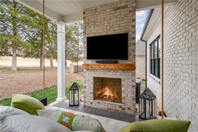 view of patio with an outdoor brick fireplace