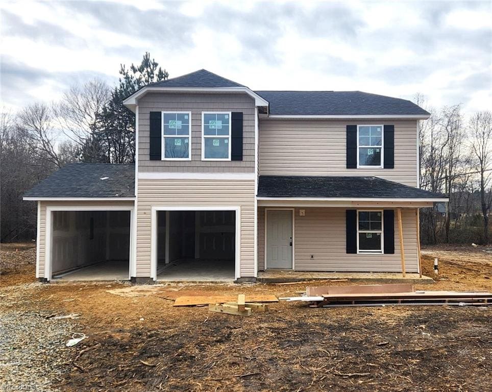 view of front property featuring a garage and covered porch