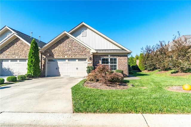 view of front of home with a front yard and a garage