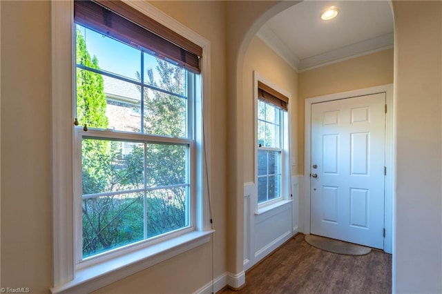 doorway to outside featuring crown molding and hardwood / wood-style flooring