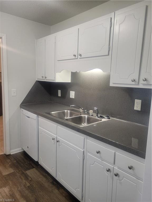 kitchen featuring dark wood-type flooring, sink, tasteful backsplash, dishwasher, and white cabinets