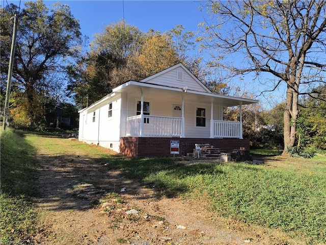 view of front of house featuring a front yard and a porch