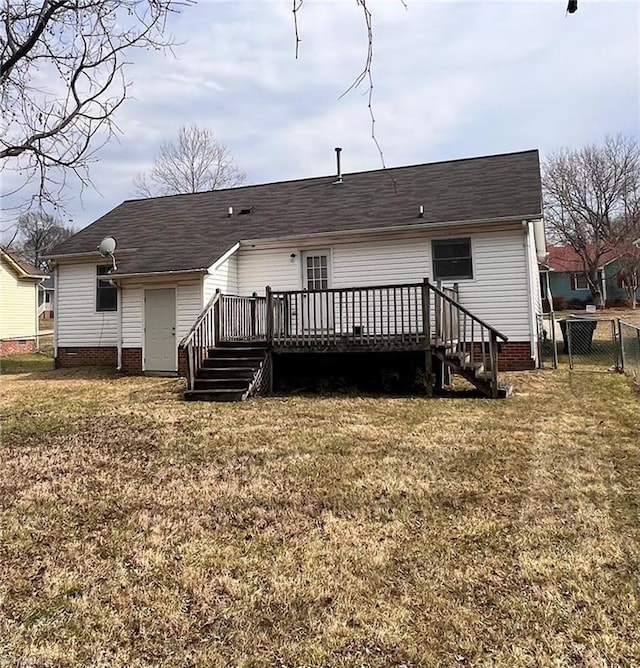 rear view of house with a deck, crawl space, fence, and a lawn