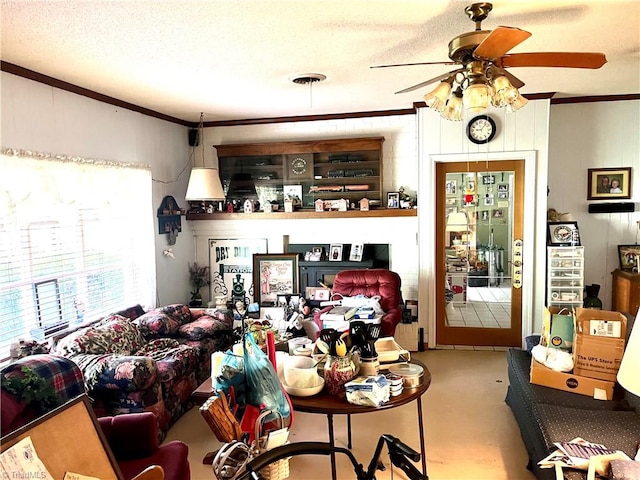 interior space featuring ceiling fan, a textured ceiling, crown molding, and concrete flooring