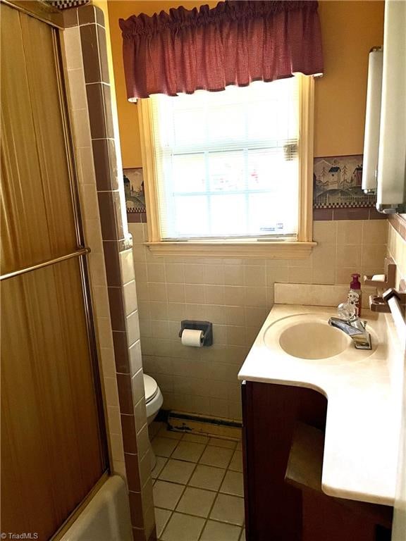 full bathroom with vanity, toilet, independent shower and bath, tile walls, and tile patterned flooring