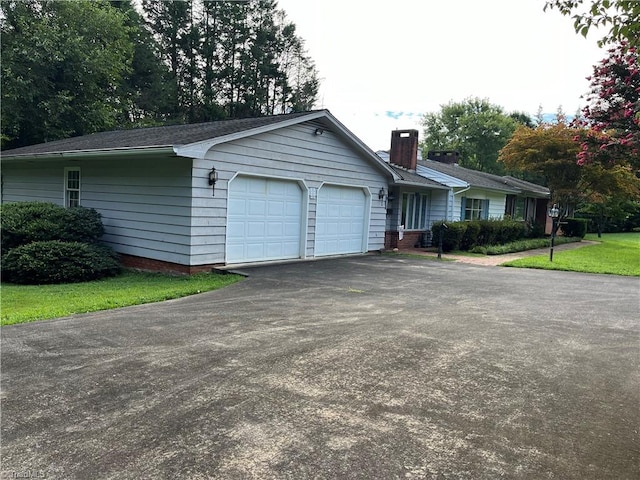 view of front of house with a garage and a front lawn