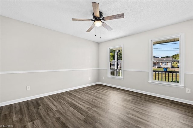 unfurnished room with a textured ceiling, dark hardwood / wood-style floors, and ceiling fan