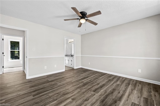 unfurnished room featuring a textured ceiling, ceiling fan, and dark hardwood / wood-style floors