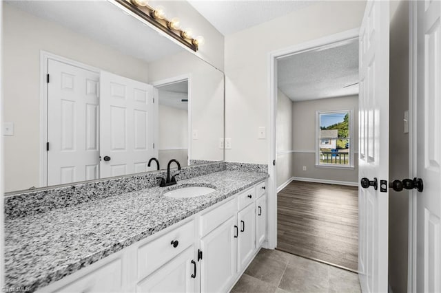 bathroom featuring vanity and a textured ceiling