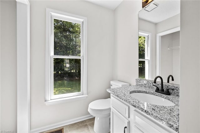 bathroom with vanity and toilet