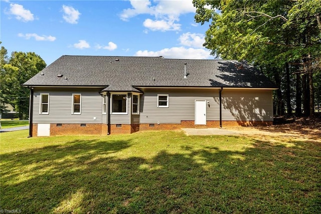 rear view of house with a lawn