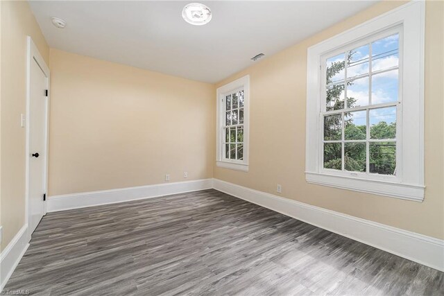 2515 N Patterson Ave, Winston-Salem, NC 27105 - unfurnished room with dark wood-type flooring, plenty of natural light, and baseboards