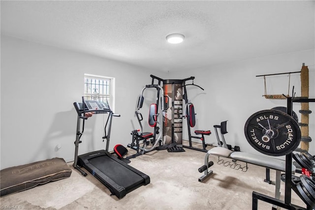 exercise room featuring a textured ceiling