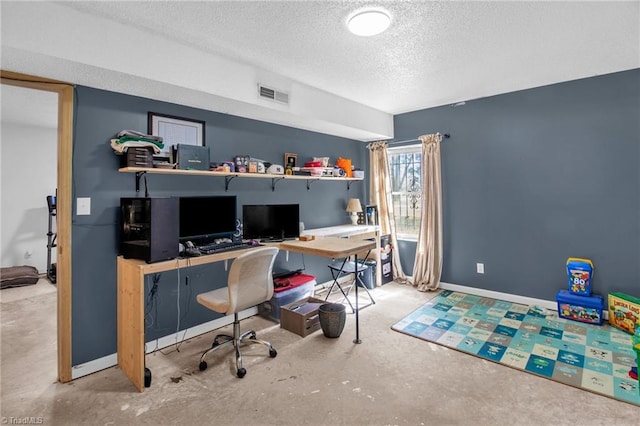 home office featuring a textured ceiling, baseboards, visible vents, and unfinished concrete floors