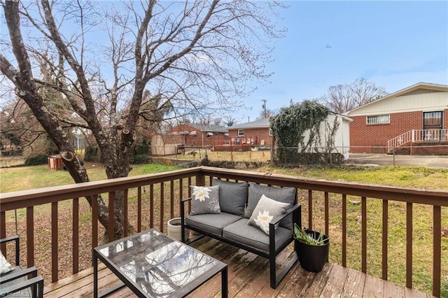 wooden terrace with outdoor lounge area, a yard, and a fenced backyard