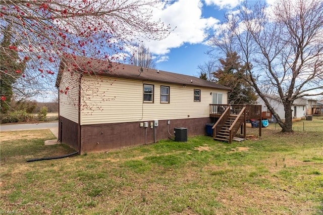 back of property with central AC, a yard, stairway, and a wooden deck