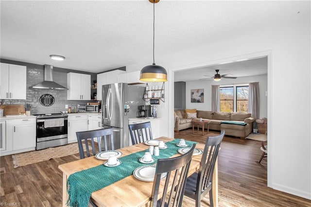 dining room featuring ceiling fan, a textured ceiling, and wood finished floors