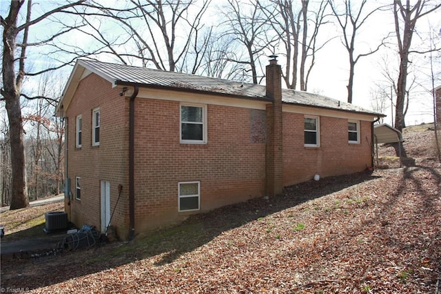 177 Duke Rd, Mount Airy, NC 27030 - view of side of property featuring brick siding, metal roof, a chimney, and central air condition unit