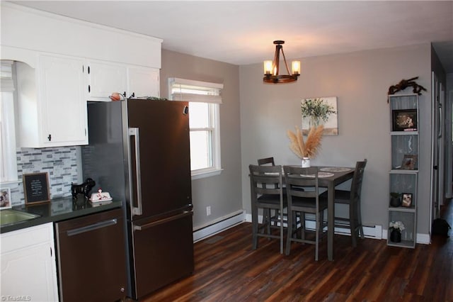 177 Duke Rd, Mount Airy, NC 27030 - kitchen featuring stainless steel appliances, dark countertops, tasteful backsplash, a baseboard heating unit, and white cabinets