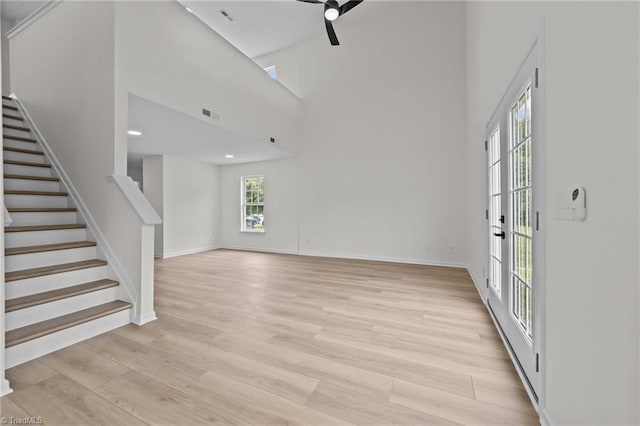 4908 Peppercorn Ln, Greensboro, NC 27406 - unfurnished living room featuring stairway, light wood-type flooring, a high ceiling, ceiling fan, and recessed lighting