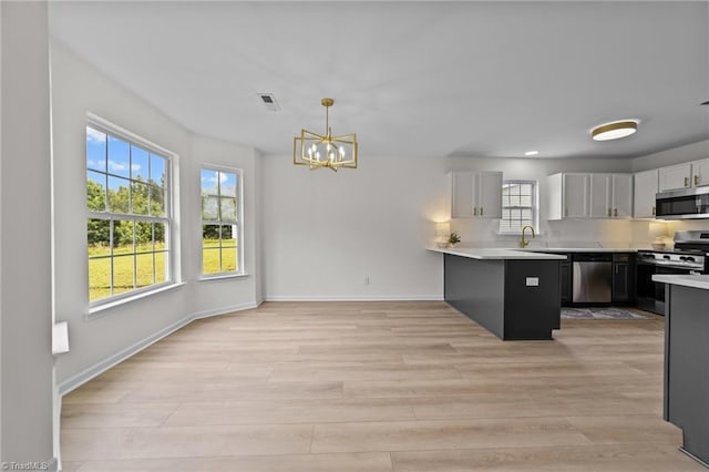 4908 Peppercorn Ln, Greensboro, NC 27406 - kitchen with stainless steel appliances, plenty of natural light, light countertops, and recessed lighting
