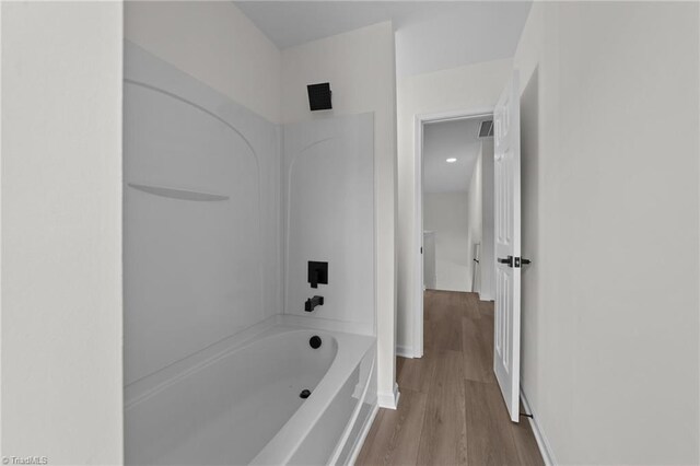 4908 Peppercorn Ln, Greensboro, NC 27406 - bathroom featuring bathing tub / shower combination and wood finished floors