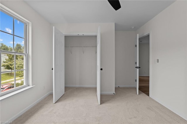 4908 Peppercorn Ln, Greensboro, NC 27406 - unfurnished bedroom with carpet, a closet, and a ceiling fan