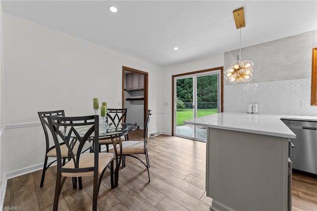 dining space featuring a notable chandelier and light wood-type flooring