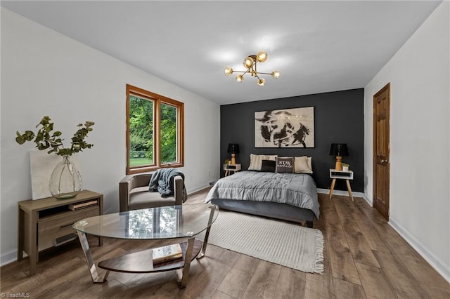 bedroom with an inviting chandelier and wood-type flooring