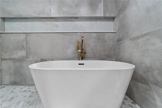 bathroom with a tub to relax in, tile walls, and tile patterned flooring