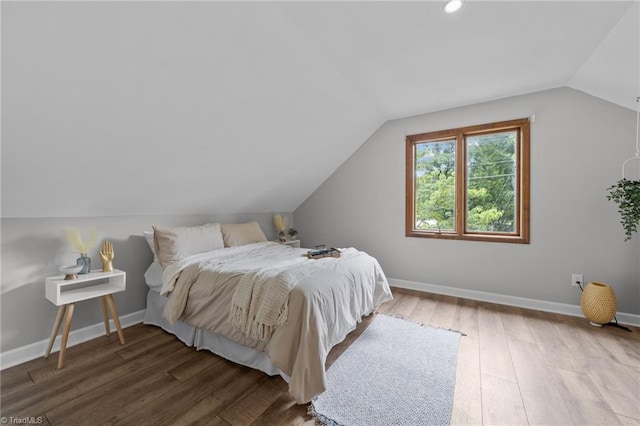 bedroom featuring lofted ceiling and wood-type flooring