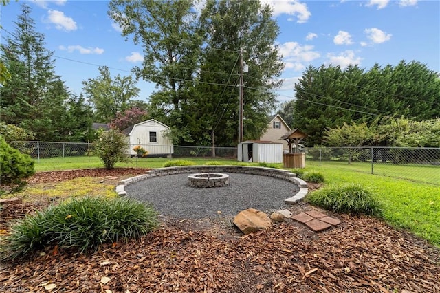 view of yard featuring an outdoor fire pit and a shed