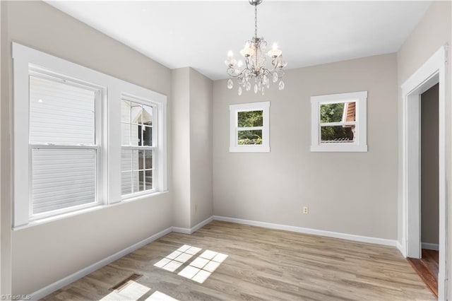 interior space featuring light hardwood / wood-style floors and a notable chandelier