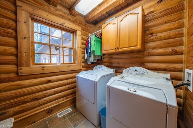 laundry room with wooden ceiling, cabinets, washing machine and dryer, and log walls