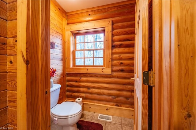 bathroom featuring toilet and rustic walls