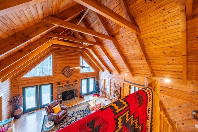 living room featuring wood-type flooring, wooden ceiling, beam ceiling, and a wealth of natural light