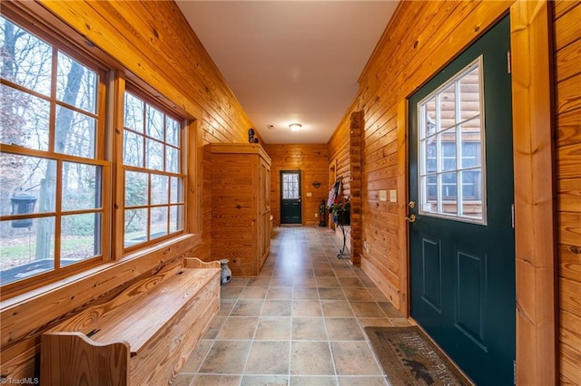 doorway to outside featuring wooden walls