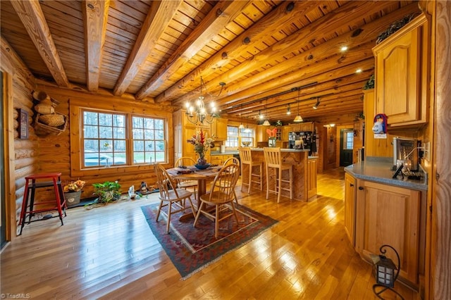 dining area with wood ceiling, beamed ceiling, rustic walls, a chandelier, and light hardwood / wood-style flooring