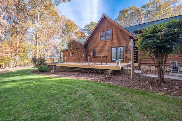 rear view of property with a lawn and a wooden deck