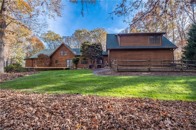 back of house with a lawn