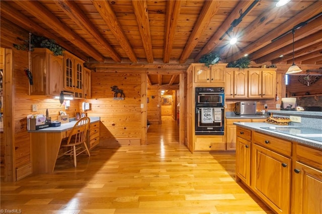 kitchen with light hardwood / wood-style flooring, decorative light fixtures, beam ceiling, black double oven, and wooden walls