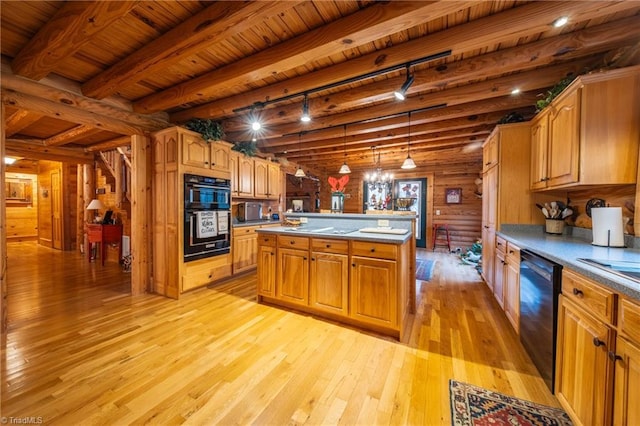 kitchen with track lighting, log walls, wooden ceiling, an island with sink, and black appliances