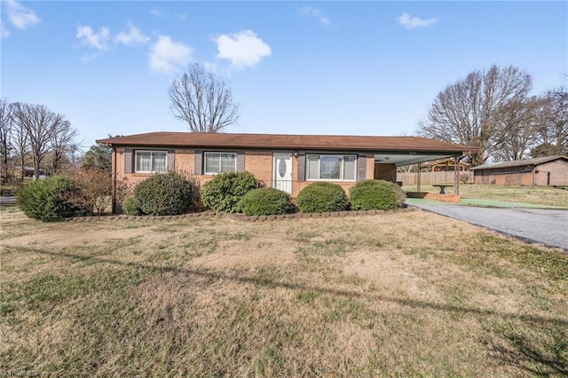 ranch-style home with a front lawn and a carport