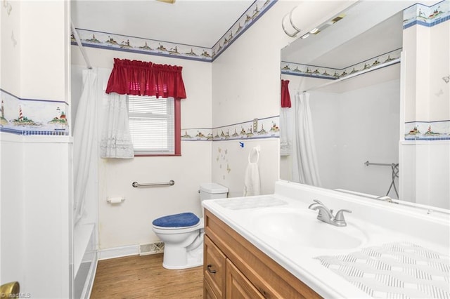 full bathroom featuring toilet, vanity, wood-type flooring, and shower / bathtub combination with curtain