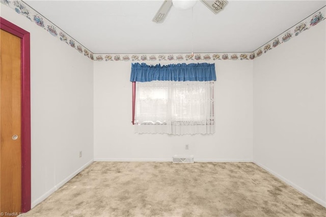 unfurnished room with ceiling fan and carpet floors