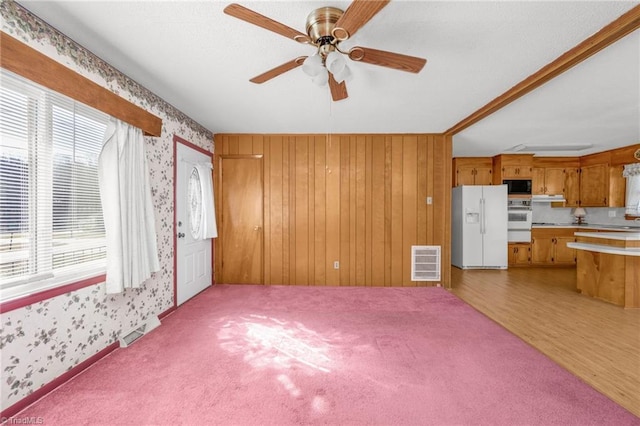 unfurnished living room featuring light wood-type flooring and ceiling fan