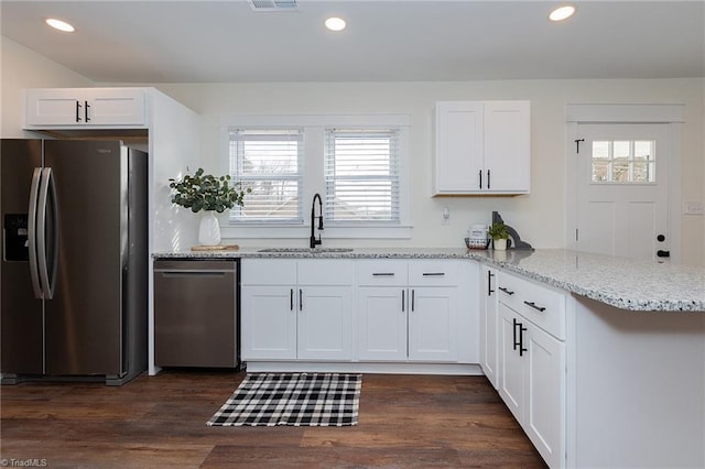 kitchen featuring recessed lighting, white cabinetry, stainless steel appliances, and a sink