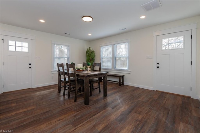 dining area with dark wood finished floors, visible vents, a healthy amount of sunlight, and recessed lighting